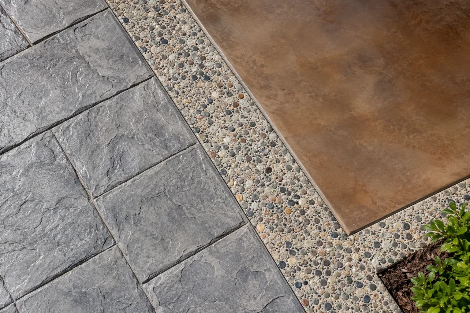 Stamped, exposed aggregate and stained concrete finishes meeting